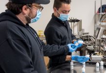 CBD and Coronavirus: Despite Crisis, Industry Still Delivering Good Vibes Brendan-McDermott-and-Alex-Althaus-looking-over-production-line-Nu-X-coronavirus-CBD-CBDToday