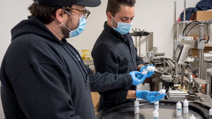 Brendan-McDermott-and-Alex-Althaus-looking-over-production-line-Nu-X-coronavirus-CBD-CBDToday