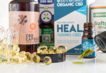 Joliet, Illinois / USA - December 9, 2018: Medicinal hemp CBD oil packages, capsules and tinctures displayed on a white background